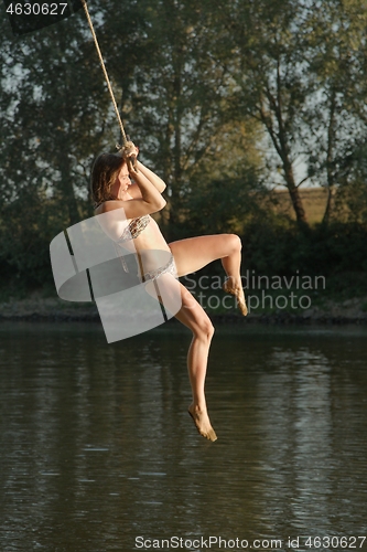 Image of Rope swing river jump