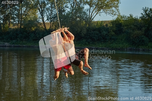 Image of Guys jumping in a river