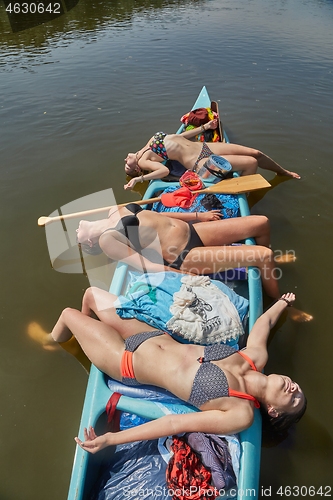 Image of Canoeing on a river, girls in the boat