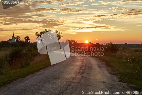 Image of Country road through in glowing sunset