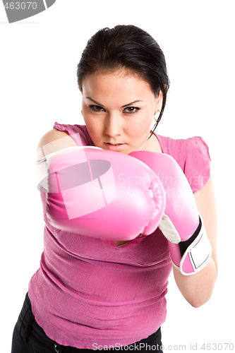 Image of Businesswoman punching with boxing gloves