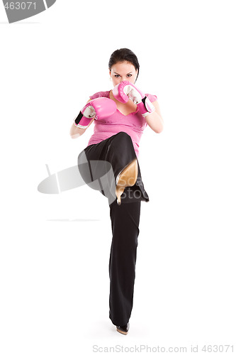 Image of Kicking businesswoman with boxing gloves