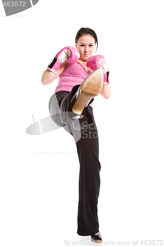 Image of Kicking businesswoman with boxing gloves