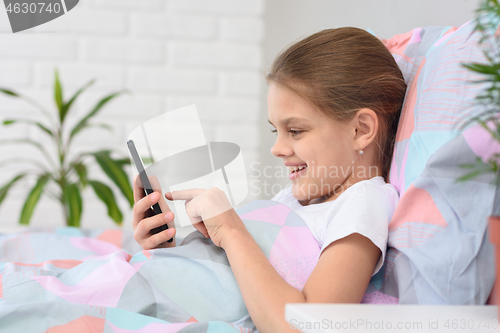Image of Girl is typing a message in a mobile phone