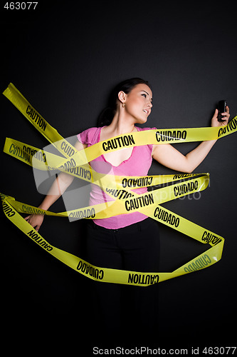 Image of Businesswoman trapped in caution tape