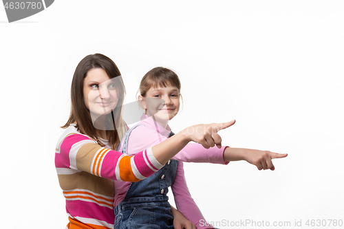 Image of Mom and girl point a finger to an empty place