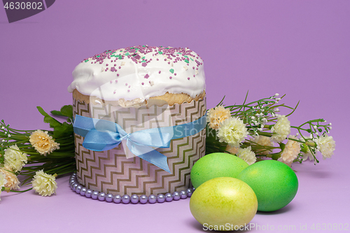 Image of beautifully decorated Easter cake with yellow-green eggs and flowers
