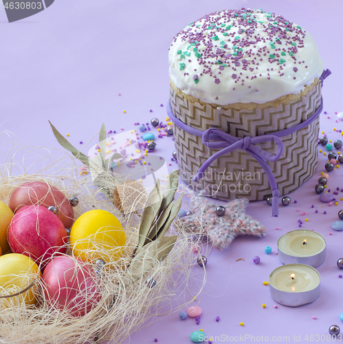 Image of Easter cake and painted eggs beautifully decorated on a lilac background