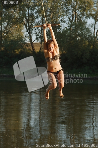Image of Rope swing river jump