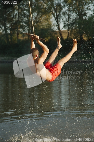 Image of Rope swing river jump