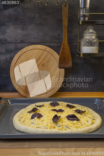 Image of Fresh raw pizza quattro formaggi with 4 sorts of cheese.