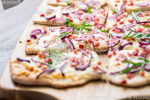 Image of Flammkuchen - Traditional French dish tarte flambee cream cheese, bacon and onions