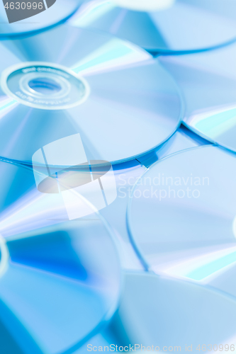 Image of Stack of CD or DVD in blue tone as background