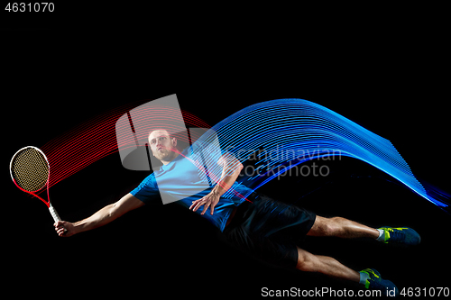 Image of one caucasian man playing tennis player on black background