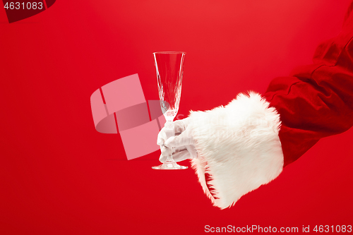 Image of Santa Holding Champagne wineglass over red
