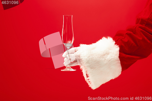 Image of Santa Holding Champagne wineglass over red