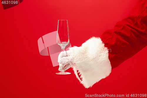 Image of Santa Holding Champagne wineglass over red