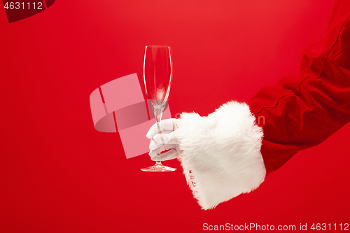 Image of Santa Holding Champagne wineglass over red