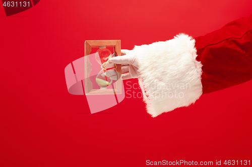 Image of Santa holding an old sand clock