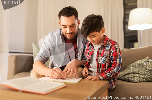 Image of father and son doing homework together