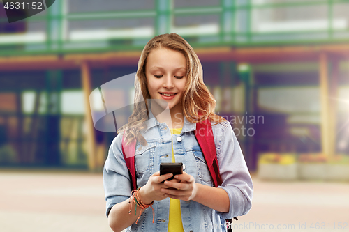 Image of teen student girl with school bag and smartphone