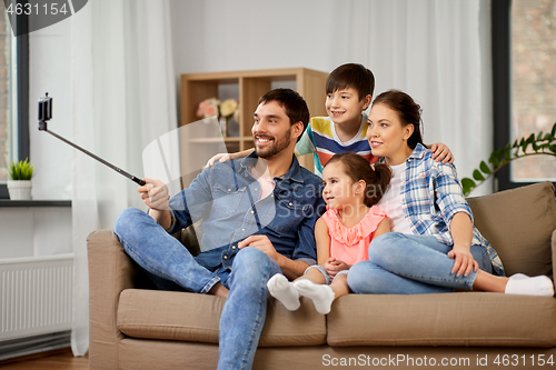 Image of happy family taking selfie at home