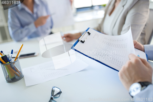 Image of business team discussing report at office