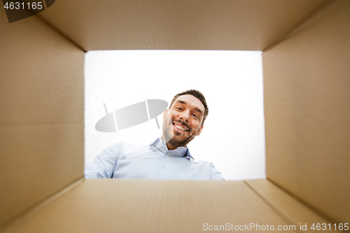 Image of man looking into open parcel box