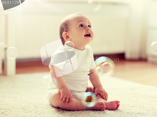 Image of happy baby with soap bubbles at home