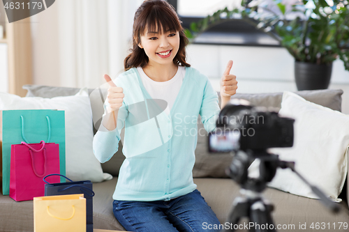 Image of female blogger making video blog about shopping