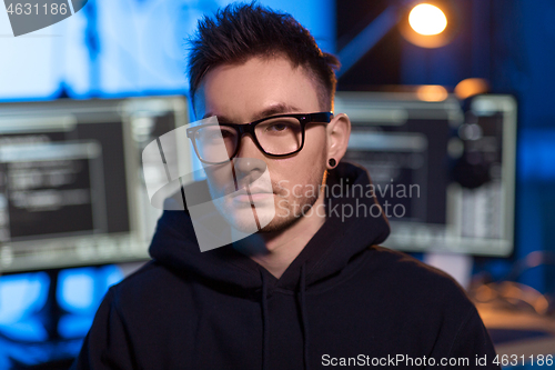 Image of asian hacker in dark room with computers at night