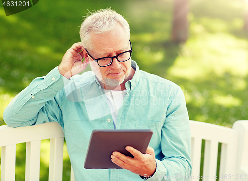 Image of senior man with tablet pc at summer park