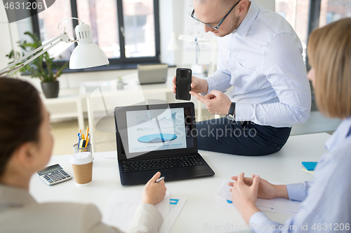 Image of business team with smartphone working at office