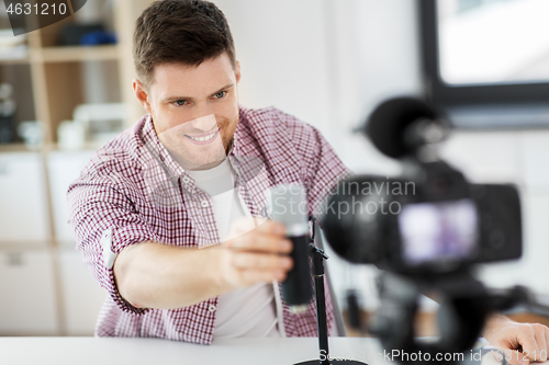 Image of male blogger with microphone videoblogging