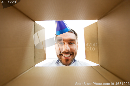 Image of happy man opening parcel box or birthday gift