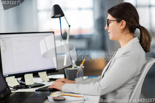 Image of businesswoman with computer working at office