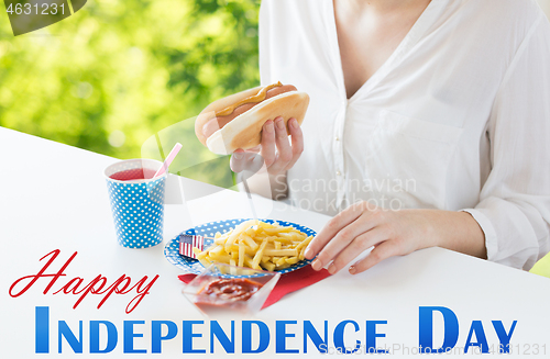 Image of close up of woman eating hotdog and french fries