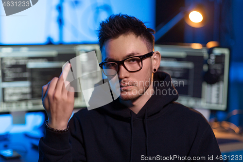 Image of hacker with computers showing middle finger