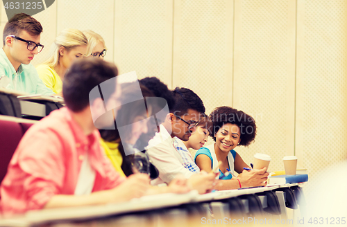 Image of group of students with coffee writing on lecture