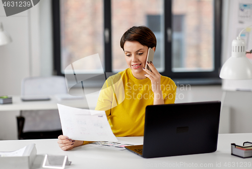 Image of ui designer calling on smartphone at office