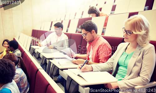 Image of group of students writing test at lecture hall