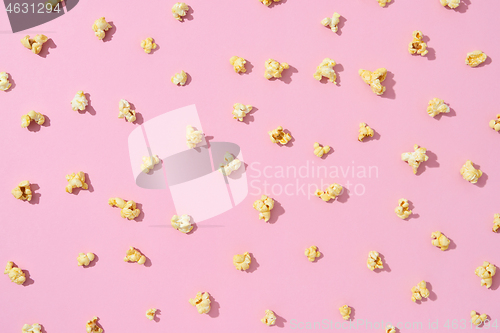 Image of Food pattern from delicious popcorn on a light pink background.