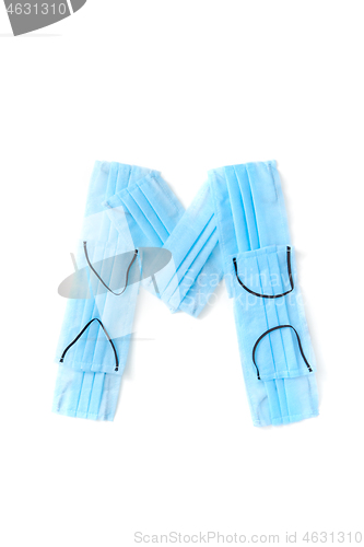 Image of Letter M made from protective medical masks on a white background.