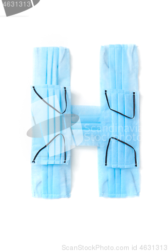 Image of Letter H made from protective medical masks on a white background.