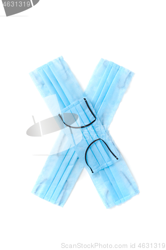 Image of Letter X made from protective medical masks on a white background.