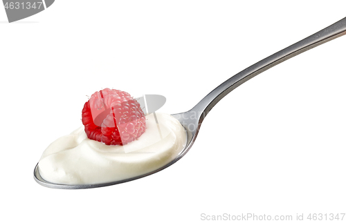 Image of spoon of yogurt cream with raspberry