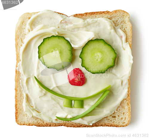 Image of funny toasted bread with cream cheese and vegetables