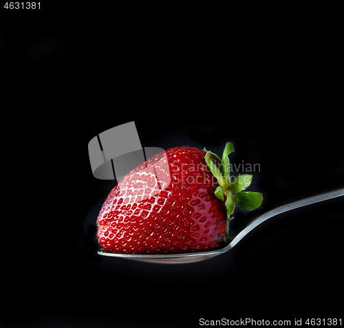 Image of fresh ripe strawberry on black background