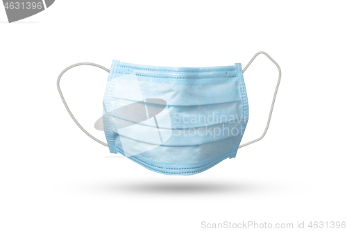 Image of Flying medical mask above white background with soft shadows.