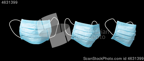 Image of Three medical masks for protection on a black background.